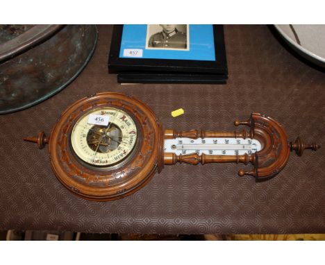 A carved walnut cased barometer/thermometer AF