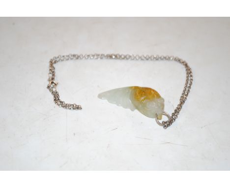 A vintage silver chain with a jade pendant in the form of a goldfish