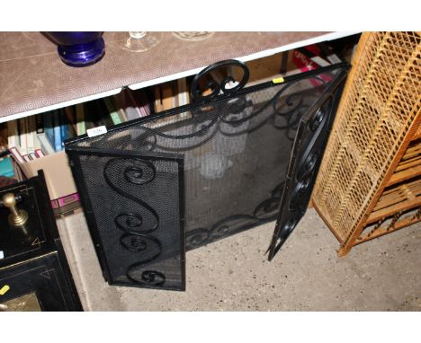 A wrought iron firescreen