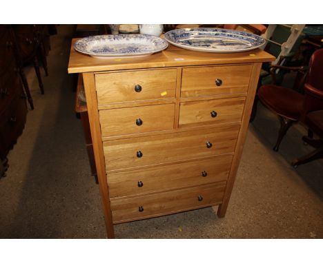 A modern light oak chest fitted four short over three long drawers