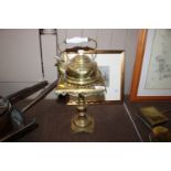 A brass kettle with porcelain handle and a brass t