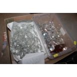 A box containing various chandelier prisms and oth