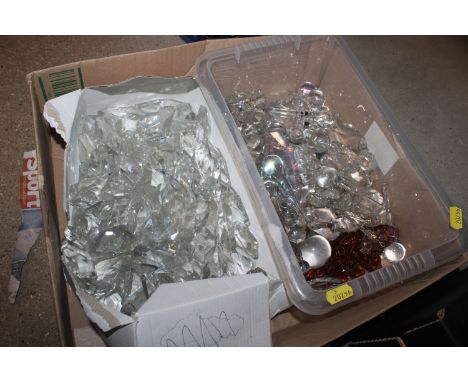 A box containing various chandelier prisms and other drops 