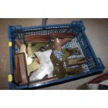 A plastic crate containing various brass fire plac