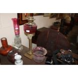 A Victorian Corinthian columned oil lamp with red