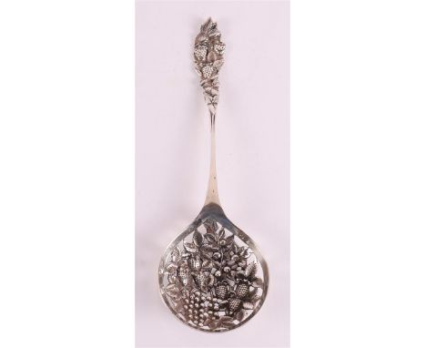 A second grade 835/1000 silver wet fruit scoop, year letter 1933. Round decorated container with relief decoration of fruit, 