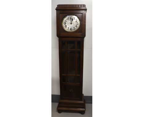 A grandfather clock, Germany, ca. 1930. Oak casing, copper dial with Arabic numerals, weights and pendulum, h190 cm.