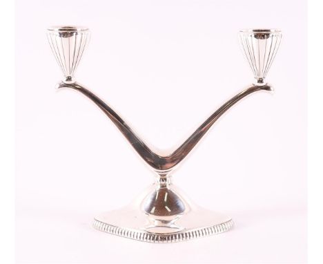 A second grade 835/1000 silver 2-light candlestick, 20th century, gross weight 293 grams.