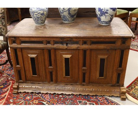 An oak and ebony blanket chest with hinged flat lid, resting on sled legs, Holland, late 17th century, h 69 x w 122 x d 64 cm