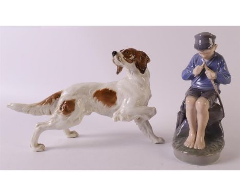 A porcelain seated boy with pocket knife, Royal Copenhagen, 20th century. Marked on the bottom, height 18.5 cm. Here is a por