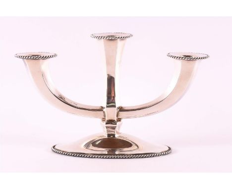 A second grade 835/1000 silver 3-light candlestick, 20th century, weighted. Gross weight 439 grams.
