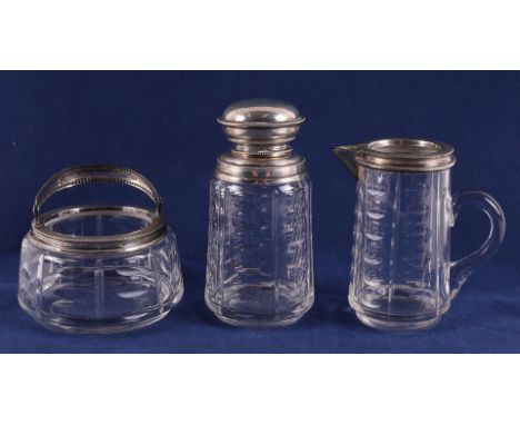 A three-piece clear crystal cream set, 20th century. Consisting of: tea caddy, sugar bowl and milk jug, all with silver frame