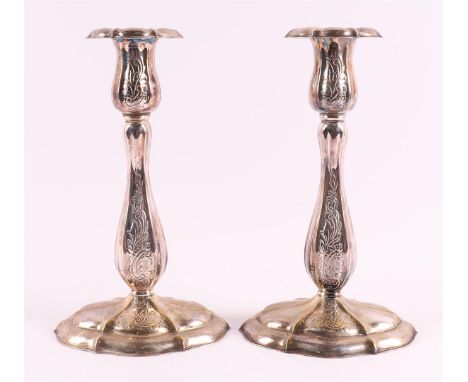 A pair of silver-plated one-light candlesticks, 1st half of the 20th century. Chiseled floral decor, h 20 cm, tot. 2x.
