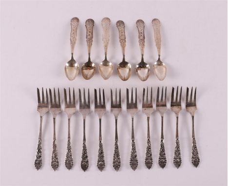 A series of eleven Djocja 3rd grade 800/1000 silver cake forks, Indonesia, early 20th century. Floral pattern crowning the st