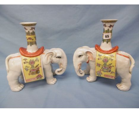 A pair of decorative ceramic elephant vases, 27cm approx.