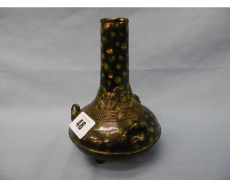A Chinese glazed vase on tripod feet, with three handles, marked to base, 15 cms high