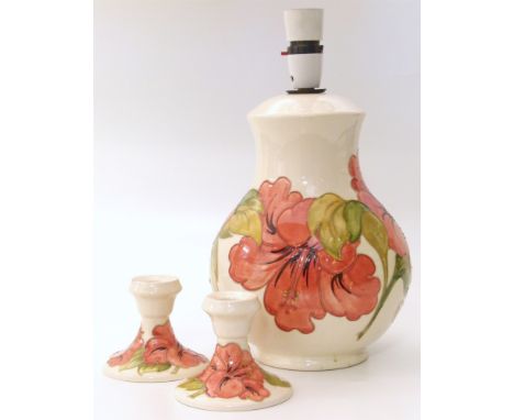 Moorcroft Hibiscus pattern lamp and two candlesticks Unfortunately we are not doing condition reports on this sale.