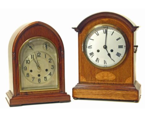 One oak mantel clock with marquetry inlay, two-train striking single gong and a lancet arched oak mantel clock, three-train m