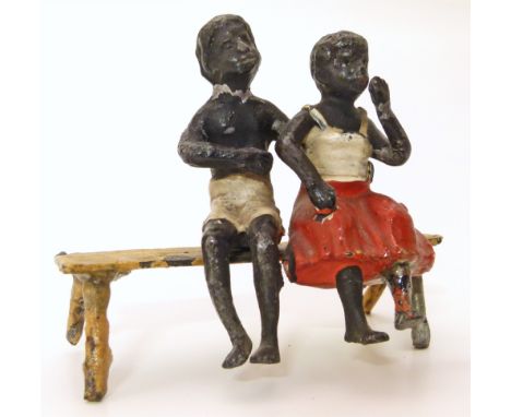 Unmarked metal ware figures of two black children on a wooden bench Unfortunately we are not doing condition reports on this 