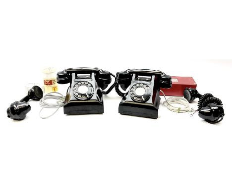 Two vintage black Bakelite telephones, with rotary dials, together with two Bakelite handsets. 