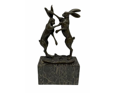 Bronze figure group, modelled as two male hares boxing, upon a naturalistic base signed 'Nick' and with foundry mark, raised 