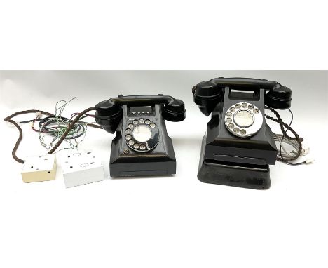 Two vintage black Bakelite telephones, with rotary dials. 