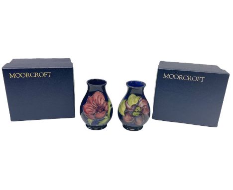 Two Moorcroft vases of baluster form, the first example decorated in the Clematis pattern, with paper label beneath, the seco