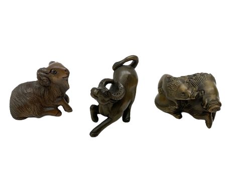 Three netsuke, modelled as a ram, buffalo and warthog mother and child