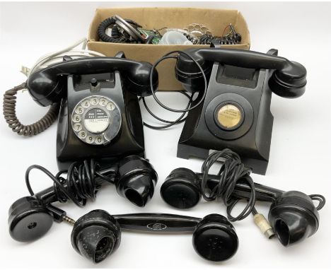 Two vintage black Bakelite telephones, one with a rotary dial and one 'call to exchange', together with three spare Bakelite 
