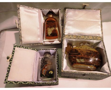 Three Chinese snuff bottles, largest H: 11 cm, boxed. P&amp;P Group 2 (£18+VAT for the first lot and £3+VAT for subsequent lo