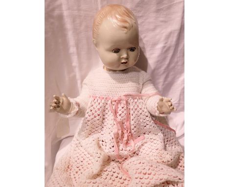 Large plastic doll, H: 60 cm, with sleep eyes and sound box to back, made in England by The Sarold Manufacturing Company. P&a