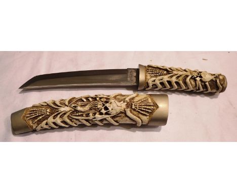 Skeleton decorated sheath knife, blade L: 20 cm. P&amp;P Group 2 (£18+VAT for the first lot and £3+VAT for subsequent lots) 