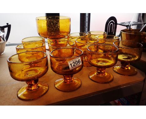 Mid 20th century amber glass dessert service in the Whitefriars style, with a large footed bowl (chip to rim), and a set of t