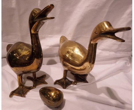 Pair of brass door stops , largest H: 20 cm, and a decorative brass egg. P&amp;P Group 2 (£18+VAT for the first lot and £3+VA