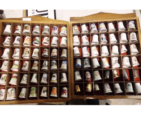 Eighty four mixed ceramic thimbles with display shelves. Not available for in-house P&amp;P 