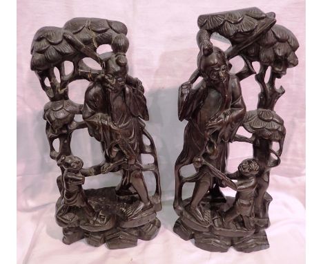 Two wooden hand carved Oriental figurines, one with repaired damage, H: 35 cm. P&amp;P Group 3 (£25+VAT for the first lot and