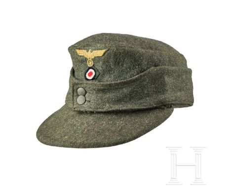 A Field Cap for Other Ranks   Cap body in coarse field-grey green wool, turn-up ear/neck flap with two field-grey finished pe
