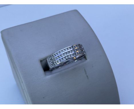 An 18ct white gold and 3 row diamond ring. R.