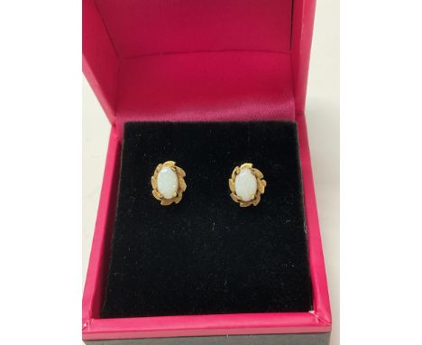 A pair of 9ct gold stud earrings set with white opal.