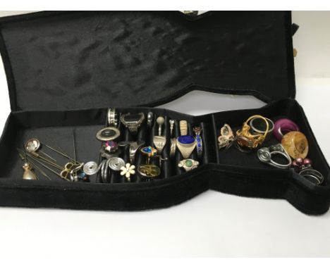 A jewellery box containing 8 silver rings, costume rings and 23 hat stick pins.