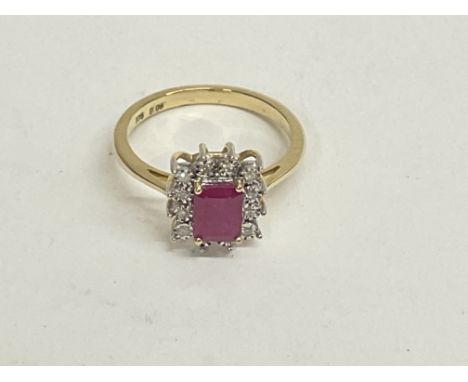 9ct yellow gold step cut ruby and diamond halo ring. Ruby 1.40ct. Round cut diamonds 0.06ct