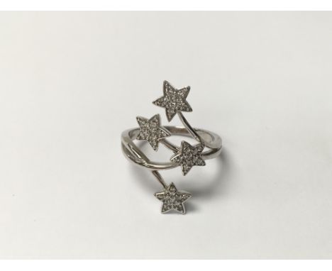 A 9ct white gold modern design ring set with diamonds forming four stars. The approximate ring size is between R and S.