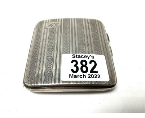 A hallmarked silver cigarette case with engine turned decoration.