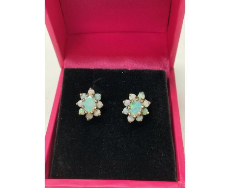 A pair of 9ct gold cluster earrings set with opal.