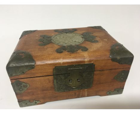 A Chinese trinket box the top inset with jade type carving and containing a quantity of coinage various.