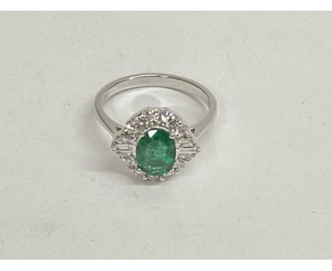 18ct white gold oval emerald and diamond cluster ring. Emerald 1.20ct. RBC and tapered baguette diamonds 0.50ct