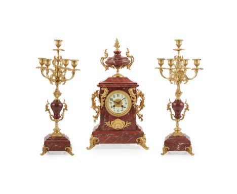 FRENCH ROUGE MARBLE AND GILT METAL CLOCK GARNITURE EARLY 20TH CENTURY the signed cream enamel dial with Arabic numbers and tw