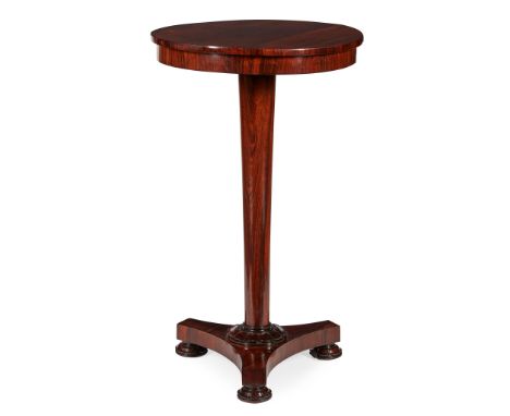 REGENCY MAHOGANY LAMP TABLE EARLY 19TH CENTURY the circular top on a tapering column and concave triform base with carved bun