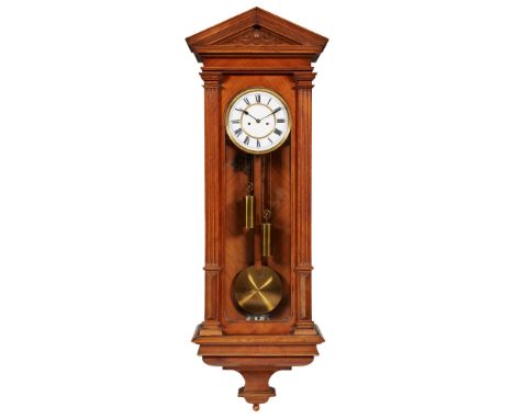 VIENNA MAHOGANY WALL REGULATOR LATE 19TH CENTURY the white enamel dial with Roman numbers and two winding holes, in an archit