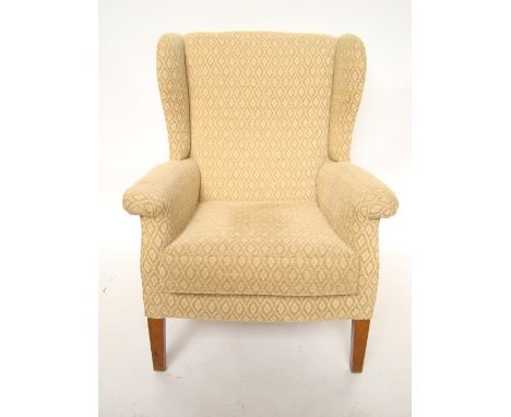 A Parker Knoll upholstered wing armchair, model no 711. 
